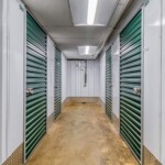 Hallway of indoor climate-controlled storage units with green doors